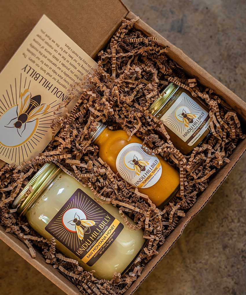 A gift box with raw honey, tonic, and herbal honey