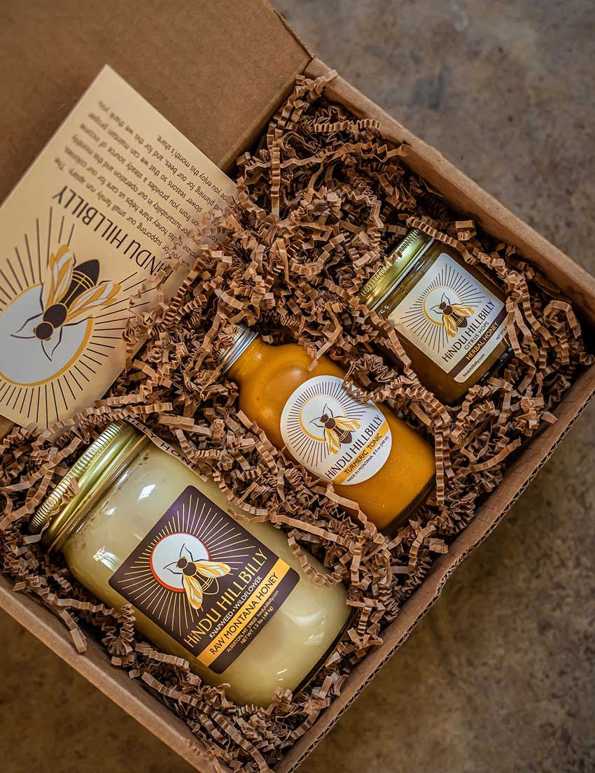 A gift box with raw honey, tonic, and herbal honey