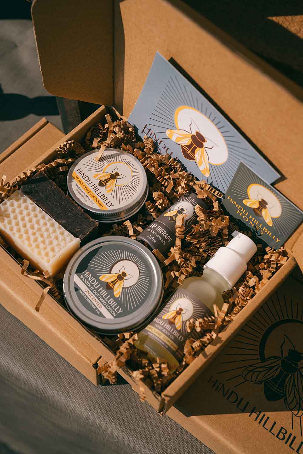 Set of products including jars, bottles, and a bar of soap in a box with 'Mud Pie' branding.