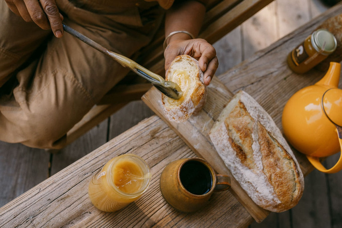 spreading-honey-on-fresh-baguette.jpg